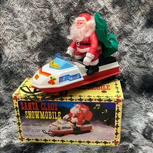 Vintage Santa Claus Snowmobile Toy with Green and Red Accents